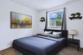 Hamilton apartment for rent - A bedroom with a large bed and a painting on the wall.