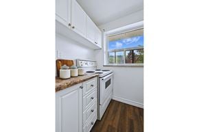 Hamilton apartment for rent - A kitchen with white cabinets and a window.