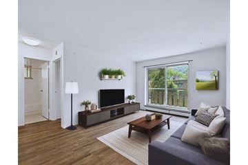 Hamilton apartment for rent - A living room with a grey couch and a wooden coffee table.