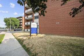 Hamilton apartment for rent - A sign for Glendale Manor Apartments stands in front of a brick building.