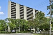 Hamilton apartment for rent - A large building with a lot of windows and a sign in front of it.