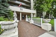 Hamilton apartment for rent - A building with the number 70 on it has a white fence and statues on it.