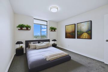 Hamilton apartment for rent - A bedroom with a large bed and two paintings on the wall.