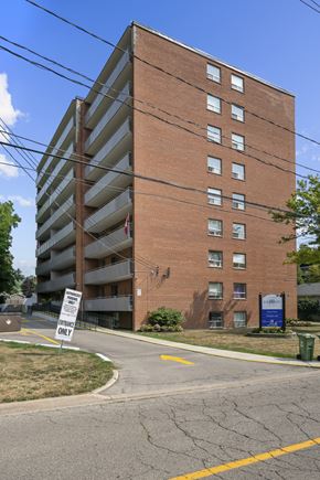 Dundas apartment for rent - A tall brick building with a sign that says "ONLY" in front of it.