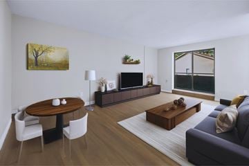 Dundas apartment for rent - A living room with a wooden table and chairs, a couch, and a painting on the wall.