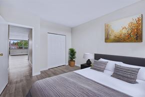 Hamilton apartment for rent - A bedroom with a large bed and a painting on the wall.
