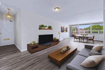 Hamilton apartment for rent - A modern living room with a grey sofa and a wooden coffee table.