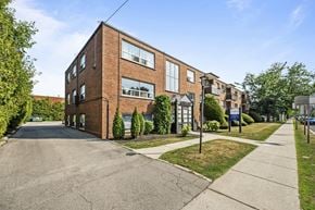 Hamilton apartment for rent - A red brick building with a green lawn in front.