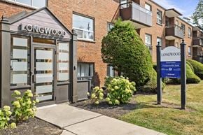 Hamilton apartment for rent - The front of a brick building with a sign that says Longwood.