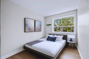 Hamilton apartment for rent - A bedroom with a large bed and two framed pictures on the wall.