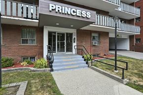 Hamilton apartment for rent - The entrance to a building named Princess with a glass door and steps leading up to it.