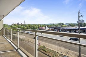 Stoney Creek apartment for rent - A view from a balcony overlooking a busy highway.