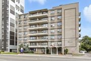 Hamilton apartment for rent - A large apartment building with a balcony on the second floor.