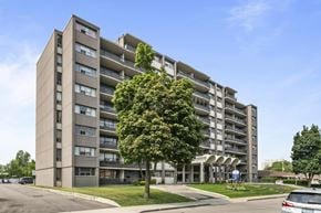 Hamilton apartment for rent - A large apartment building with a tree in front of it.