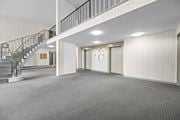 Hamilton apartment for rent - A spacious room with a staircase and two doors.
