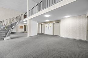 Hamilton apartment for rent - A spacious room with a staircase and two doors.