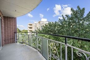 Stoney Creek apartment for rent - A balcony with a metal railing and a view of apartment buildings.