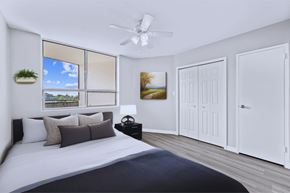 Hamilton apartment for rent - A bedroom with a large bed and a ceiling fan.
