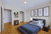 Hamilton apartment for rent - A bedroom with a bed, nightstand, and a plant on a shelf.