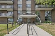 Hamilton apartment for rent - A modern building with a white arched entrance and a metal railing.