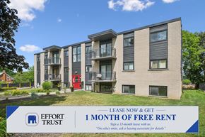 Waterloo apartment for rent - A building with a sign offering 1 month of free rent.
