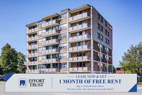Hamilton apartment for rent - A tall apartment building with a sign offering a free month of rent.