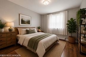 Hamilton apartment for rent - A bedroom with a bed, nightstand, and a painting on the wall.