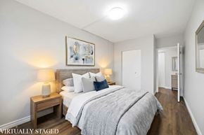 Hamilton apartment for rent - A bedroom with a bed, nightstands, and a painting on the wall.