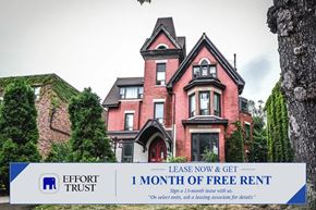 Hamilton apartment for rent - A large red house with a sign offering 1 month free rent.