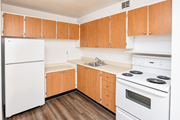 Hamilton apartment for rent - A kitchen with wooden cabinets and white appliances.