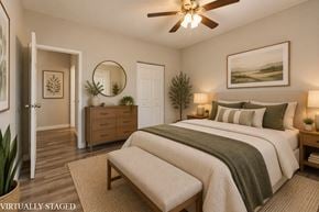 Hamilton apartment for rent - A bedroom with a bed, dresser, and mirror.