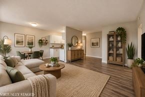 Hamilton apartment for rent - A living room with a couch, a coffee table, and a potted plant.