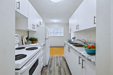 Hamilton apartment for rent - A kitchen with white cabinets and a wooden floor.