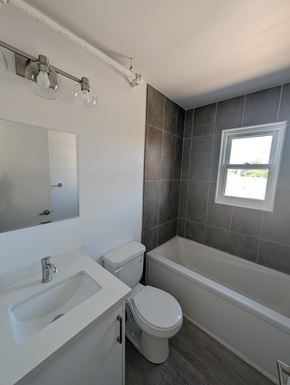 Kitchener apartment for rent - A bathroom with a toilet, sink, and bathtub.