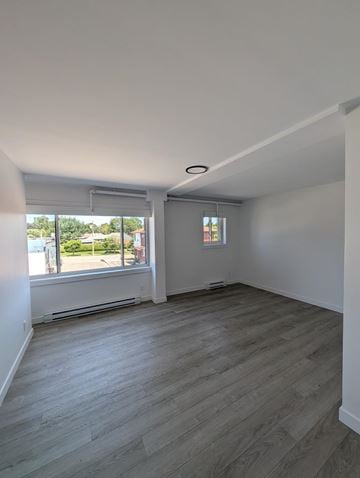 Kitchener apartment for rent - A room with a window and a wooden floor.