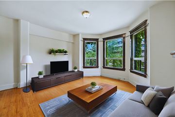 Hamilton apartment for rent - A living room with a grey couch and a wooden coffee table.