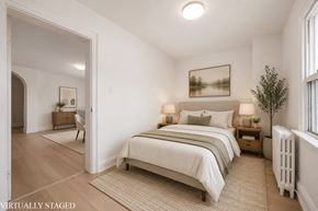 Kitchener apartment for rent - A bedroom with a large bed and a painting on the wall.