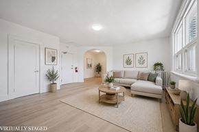 Kitchener apartment for rent - A living room with a couch, coffee table, and plants.
