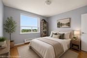 Hamilton apartment for rent - A bedroom with a large bed and a window overlooking a lake.