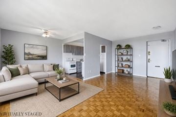 Hamilton apartment for rent - A living room with a couch, coffee table, and a painting on the wall.