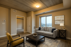 Kitchener apartment for rent - A living room with a grey couch, a yellow chair, and a coffee table.