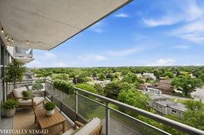 Hamilton apartment for rent - A balcony with a table and chairs overlooking a residential area.
