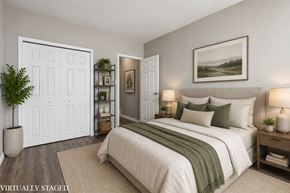 Hamilton apartment for rent - A bedroom with a bed, nightstands, and a painting on the wall.
