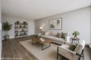 Hamilton apartment for rent - A living room with a couch, a coffee table, and a potted plant.