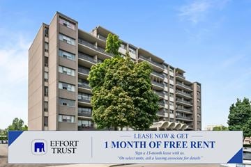 Hamilton apartment for rent - A tall building with a tree in front of it and a sign that says "1 MONTH OF FREE RENT".