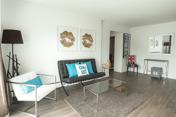 Waterloo apartment for rent - A living room with a black couch and a white chair.