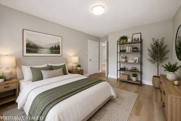 Waterloo apartment for rent - A bedroom with a large bed and a painting on the wall.
