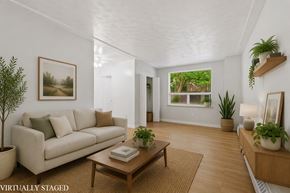 Hamilton apartment for rent - A living room with a couch, a coffee table, and a potted plant.