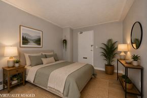 Hamilton apartment for rent - A bedroom with a bed, nightstands, and a painting on the wall.