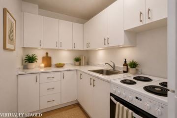 Hamilton apartment for rent - A white kitchen with a stove and sink.